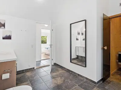 a bathroom with a mirror on the wall at 6 person holiday home in Blokhus in Blokhus