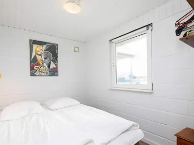 a white room with a bed and a window at 6 person holiday home in Thisted in Torsted