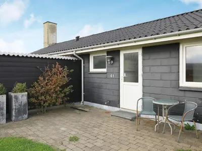 a house with a table and chairs in front of it at 6 person holiday home in Thisted in Torsted