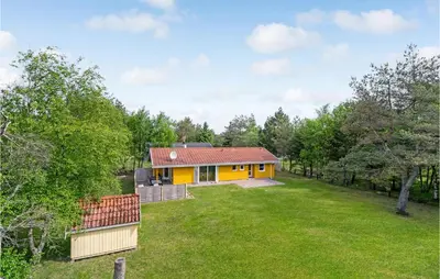 a yellow house in the middle of a yard at Stunning Home In Fjerritslev With Wifi in Fjerritslev