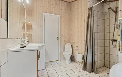 a bathroom with a toilet and a sink and a shower at Stunning Home In Fjerritslev With Wifi in Fjerritslev