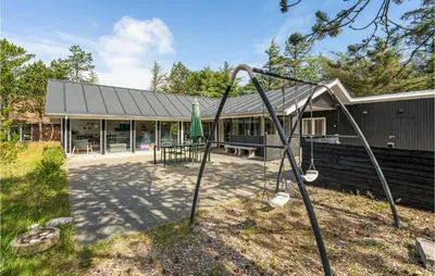 a swing set in front of a building at 4 Bedroom Beautiful Home In Vestervig in Vestervig