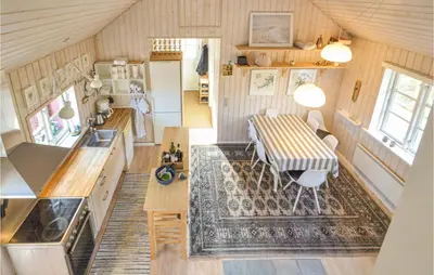 a kitchen and dining room with a table in a tiny house at Nice Home In Hurup Thy in Sønder Ydby
