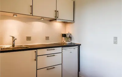a small kitchen with a sink and a microwave at Lovely Apartment In Lemvig With Kitchen in Lemvig