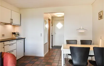 a kitchen and dining room with a table and chairs at Lovely Apartment In Lemvig With Kitchen in Lemvig