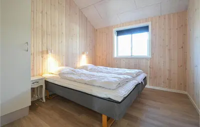 a bedroom with a bed in a room with a window at Amazing Home In Thisted With Sauna in Thisted