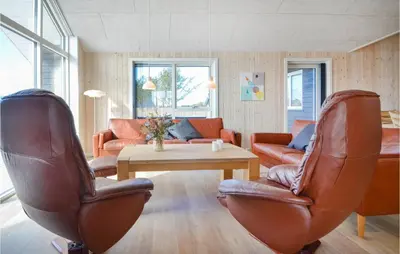 a living room with leather chairs and a table at Amazing Home In Thisted With Sauna in Thisted