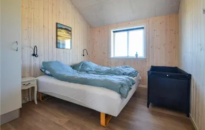 a bedroom with a bed in a room with a window at Amazing Home In Thisted With Sauna in Thisted