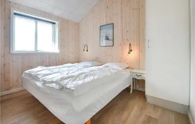 a bedroom with a white bed and a window at Amazing Home In Thisted With Sauna in Thisted