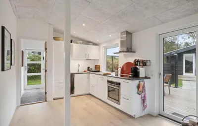 a kitchen with white cabinets and a large window at Cozy Home In Hjerm With Kitchen in Hjerm