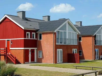 a red brick house with a black roof at 5 person holiday home on a holiday park in Lemvig in Lemvig