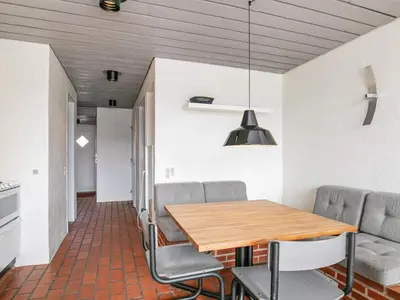 a dining room with a wooden table and chairs at 6 person holiday home in Brovst in Brovst