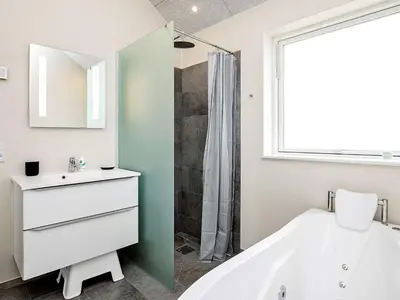 a bathroom with a tub and a sink and a shower at 10 person holiday home in Thisted in Thisted