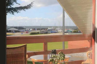 a balcony with a table and a view of a parking lot at Villa Nida in Ranum