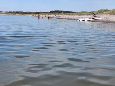 a body of water with people on the beach at Villa Nida in Ranum
