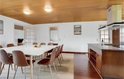 a kitchen and dining room with a white table and chairs at Gorgeous Home In Hanstholm With Kitchen in Hanstholm