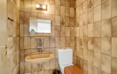 a bathroom with a toilet and a sink at Gorgeous Home In Hanstholm With Kitchen in Hanstholm