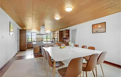 a kitchen and dining room with a white table and chairs at Gorgeous Home In Hanstholm With Kitchen in Hanstholm