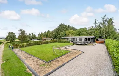 an estate with a playground and a house at Amazing Home In Roslev With Wifi in Roslev