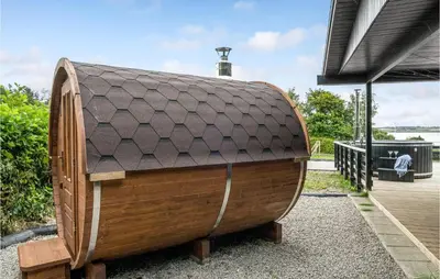 a wooden barrel with a roof on top at Amazing Home In Roslev With Wifi in Roslev