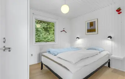 a white bedroom with a bed and a window at Amazing Home In Roslev With Wifi in Roslev