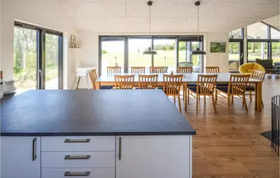 a kitchen and dining room with a table and chairs at Pet Friendly Home In Vinderup in Vinderup