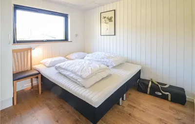 a bed in a room with a window at Pet Friendly Home In Vinderup in Vinderup