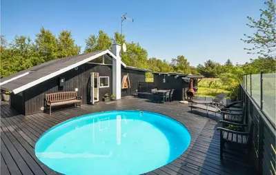 a deck with a swimming pool and a building at Gorgeous Home In Fjerritslev in Fjerritslev