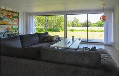 a living room with a couch and a table at Gorgeous Home In Fjerritslev in Fjerritslev