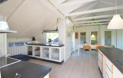 a kitchen and dining room with white walls and a ceiling at Gorgeous Home In Fjerritslev in Fjerritslev