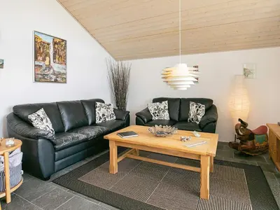 a living room with a couch and a table at 6 person holiday home in Brovst in Brovst