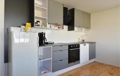 a kitchen with white appliances and a white refrigerator at Awesome Home In Harboøre With Kitchen in Harboør
