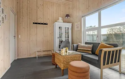 a living room with a couch and a table at Awesome Home In Vestervig With Sauna in Vestervig