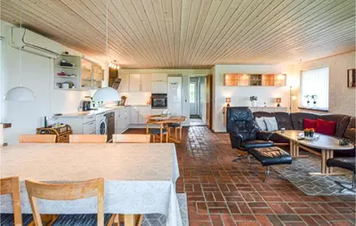 a living room and kitchen with a table and chairs at Cozy Home In Vinderup With Wifi in Vinderup