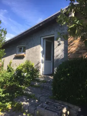 a house with a white door and a window at Holiday Home centrum Lemvig in Lemvig
