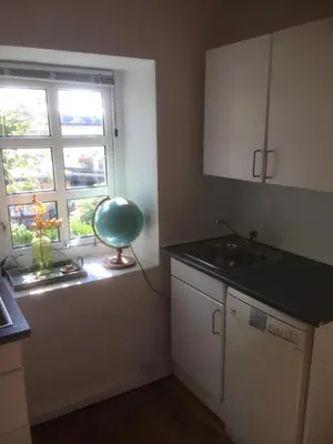 a small kitchen with a sink and a window at Holiday Home centrum Lemvig in Lemvig