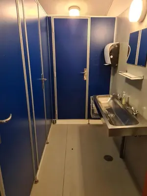a bathroom with a blue door and a sink at Stoholm Vandrehjem in Stoholm