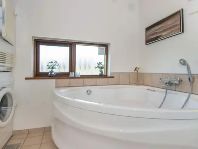 a white bath tub in a bathroom with a window at Tranquil Retreat in Thorsminde-By Traum in Ulfborg
