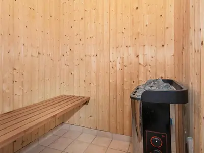 a corner of a room with a bench and a trash can at Tranquil Retreat in Thorsminde-By Traum in Ulfborg