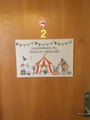 a sign on a door with a dog and a tent at Roslev Hus in Roslev