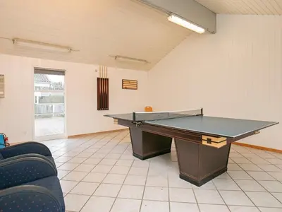 a ping pong table in a room with a ping pong ball at Luxury Retreat in Gronhoj-By Traum in Løkken