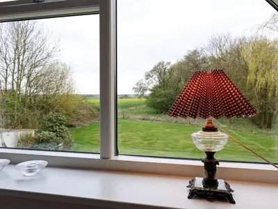 a lamp sitting on a table in front of a window at 8 person holiday home in Fur in Fur