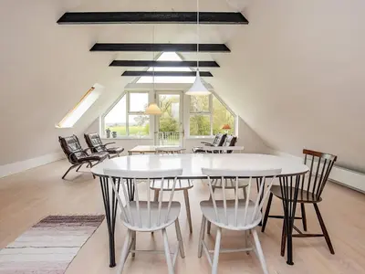 a dining room with a white table and chairs at 8 person holiday home in Fur in Fur