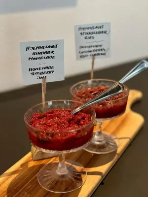two bowls of red caviar on a wooden cutting board at Hotel Steenbergs in Nykøbing Mors