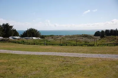 a path in a field with the ocean in the background at Sommerhus Farmen i Hanstholm in Hanstholm
