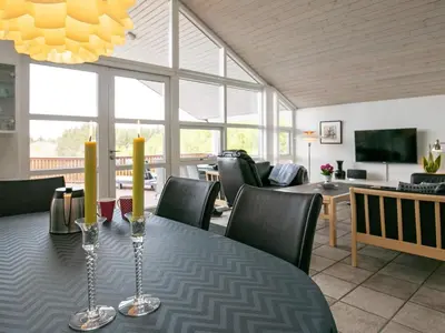 a dining room with a table and chairs at 8 person holiday home in Skals in Skals