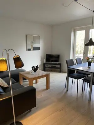 a living room with a couch and a table at Hilmor's Lejligheder in Viborg