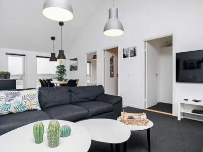 a living room with a couch and a table at 6 person holiday home in Løkken in Løkken