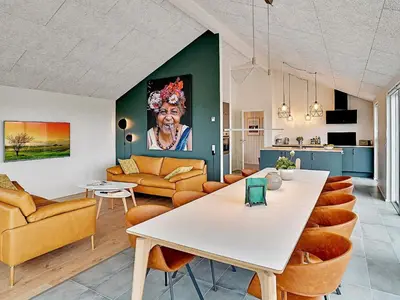 a living room with a large white table and chairs at 10 person holiday home in Løkken in Løkken