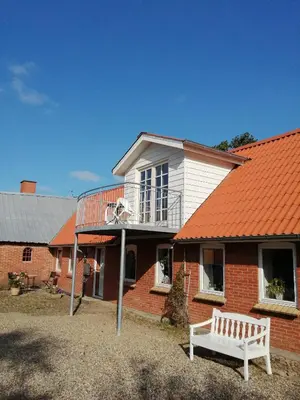 a house with an orange roof with a basketball hoop at Stenhøj Bed and Breakfast, v. Jette og Marius in Erslev